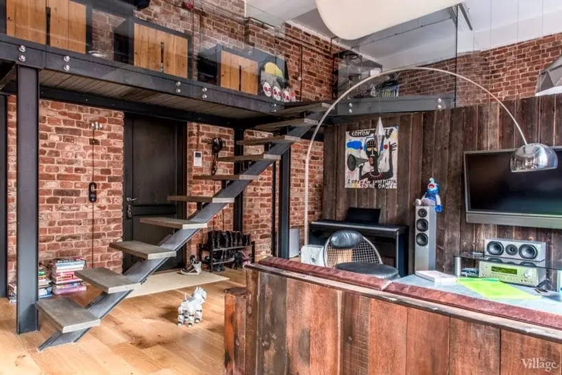 nterior de um loft espaçoso com paredes de tijolo aparente originais, vigas de aço pretas e móveis contemporâneos minimalistas